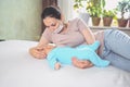 Young mother in protective face mask with newborn cute infant baby breastfeeds him with breast milk Royalty Free Stock Photo