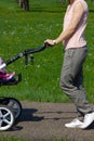 young mother pushing buggy Royalty Free Stock Photo