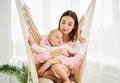 A young mother puts her baby, son, cradles, lullaby Royalty Free Stock Photo