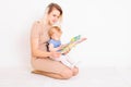 Young mother reading book for little daughter Royalty Free Stock Photo