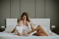 Young mother reading book to her smiling little boy Royalty Free Stock Photo