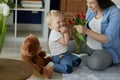 Mother receiving beautiful flowers from her toddler boy Royalty Free Stock Photo