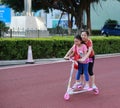 A young mother roller skating with her daughter