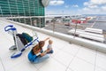 Young mother show to baby boy airplanes in airport