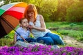 Young mother sitting with her little son in the garden. Mother`s Day concept Royalty Free Stock Photo