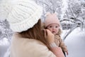 A young mother with a small child plays in the snow Royalty Free Stock Photo