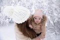 A young mother with a small child plays in the snow Royalty Free Stock Photo