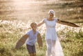 Young mother with small son playing on a meadow in nature. Royalty Free Stock Photo