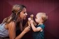 Young mother with small toddler girl outdoors in summer, eating ice cream. Royalty Free Stock Photo