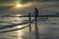 Young mother and smiling baby boy son playing on the beach on the Sunset. Positive human emotions, feelings, joy. Funny cute child Royalty Free Stock Photo