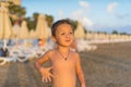 Young mother and smiling baby boy son playing on the beach on the Sunset. Positive human emotions, feelings, joy. Funny cute child Royalty Free Stock Photo