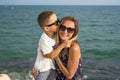 Young mother and smiling baby boy son playing on the beach on the Sunset. Positive human emotions, feelings, joy. Funny cute child Royalty Free Stock Photo