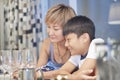 Young mother and son in dining room enjoying Royalty Free Stock Photo