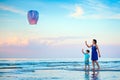 Young mother and son flying fire lantern together