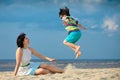 Young mother and son having fun on the beach Royalty Free Stock Photo