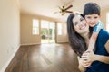 Young Mother and Son Inside Empty Room with Hard Wood Floors. Royalty Free Stock Photo