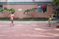 A young mother and son play badminton