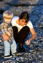 Young mother and son playing on the beach at sunset Royalty Free Stock Photo