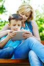 Young mother and son playing on tablet Royalty Free Stock Photo