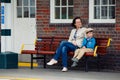 Young mother and son on railway station platform Royalty Free Stock Photo