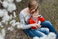 A young mother and son with smiles, play each other`s hands in t