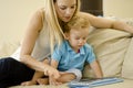 Young mother and son with a tablet Royalty Free Stock Photo
