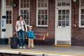 Young mother and son waiting for train on railway station Royalty Free Stock Photo