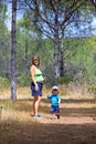 Young mother and son walking through woods Royalty Free Stock Photo