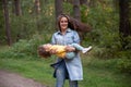 young mother is spinning with a baby in her arms. happy mom dancing with toddler on the background of nature and forest