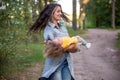 young mother is spinning with a baby in her arms. happy mom dancing with toddler on the background of nature and forest