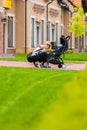 Mother carries her child in a stroller for a walk. Royalty Free Stock Photo