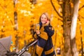 A young mother with a stroller is talking on her mobile phone while walking in the park Royalty Free Stock Photo