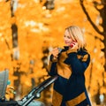 A young mother with a stroller is talking on her mobile phone while walking in the park Royalty Free Stock Photo