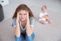 Young mother suffering from postnatal depression and little baby