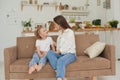 A young mother is talking heart to heart with her child. The psychologist communicates with a little girl at home Royalty Free Stock Photo