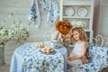 Young Mother Talks With Her Daughter At Kitchen