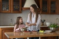 Young mother teach her little cute daughter to cook Royalty Free Stock Photo