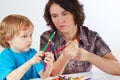 Young mother teaches her son to draw with pencils Royalty Free Stock Photo