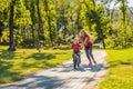 Young mother teaching her son how to ride a bicycle in the park Royalty Free Stock Photo