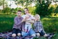 Young mother and three children having fun in nature. Happy playful family outdoors Royalty Free Stock Photo