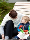 Young mother and toddler reading book outdoor Royalty Free Stock Photo