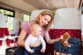 Young mother travelling with baby by train. Royalty Free Stock Photo