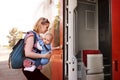 Young mother travelling with baby by train. Royalty Free Stock Photo