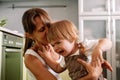 Young mother tries to calm her crying little daughter. Raising child concept