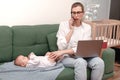 young mother trying to work, maternity leave, freelancer Royalty Free Stock Photo