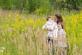 Young mother with two children in a yellow flower field Royalty Free Stock Photo