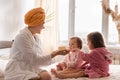 Young mother two daughters in curlers bathrobes. happy smiling family skin care concept. Mom teaches little kids child Royalty Free Stock Photo