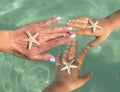 Young Mother and two sons watching starfish. Positive human emotions, feelings, joy. Funny cute child making vacations and Royalty Free Stock Photo