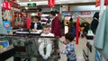 Shenzhen, China: a young mother checks out at a supermarket with her two young children