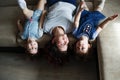 a young mother and two young daughters are lying on the sofa upside down Royalty Free Stock Photo